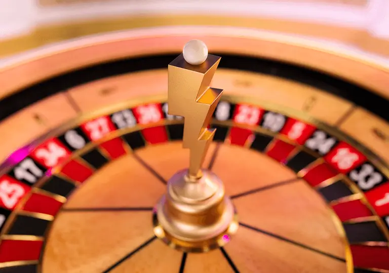 Roulette wheel with a gold lightning-bolt centre from Gates of Olympus Roulette